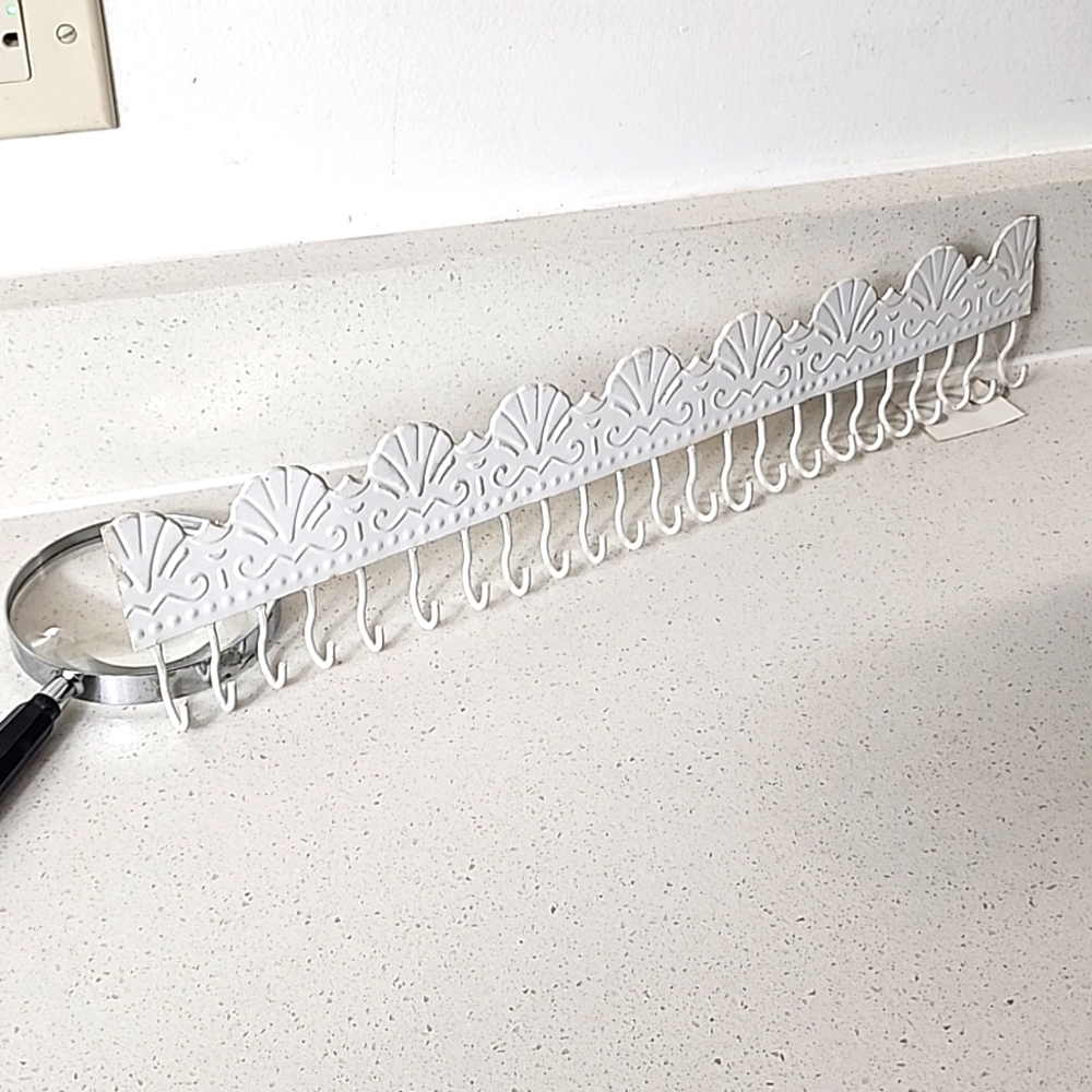 Metal strip with 23 hooks.New